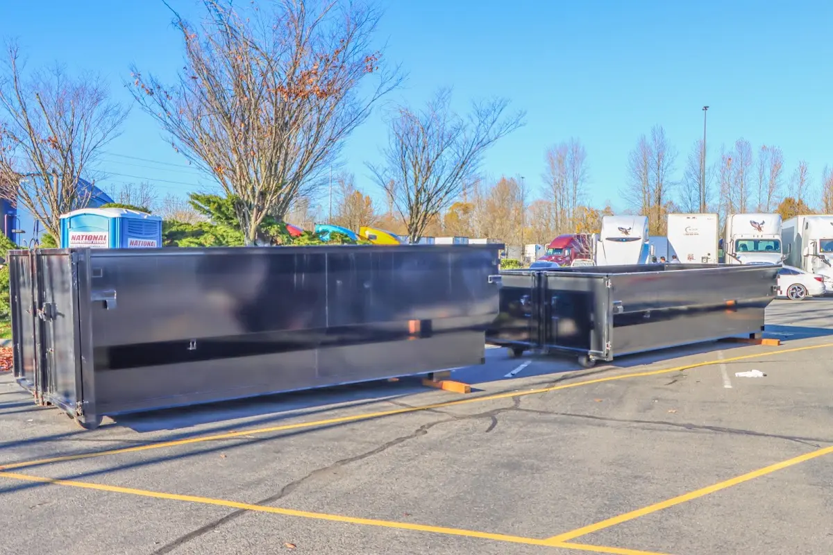 Professional dumpster rental service with roll-off container on residential driveway in Walkersville